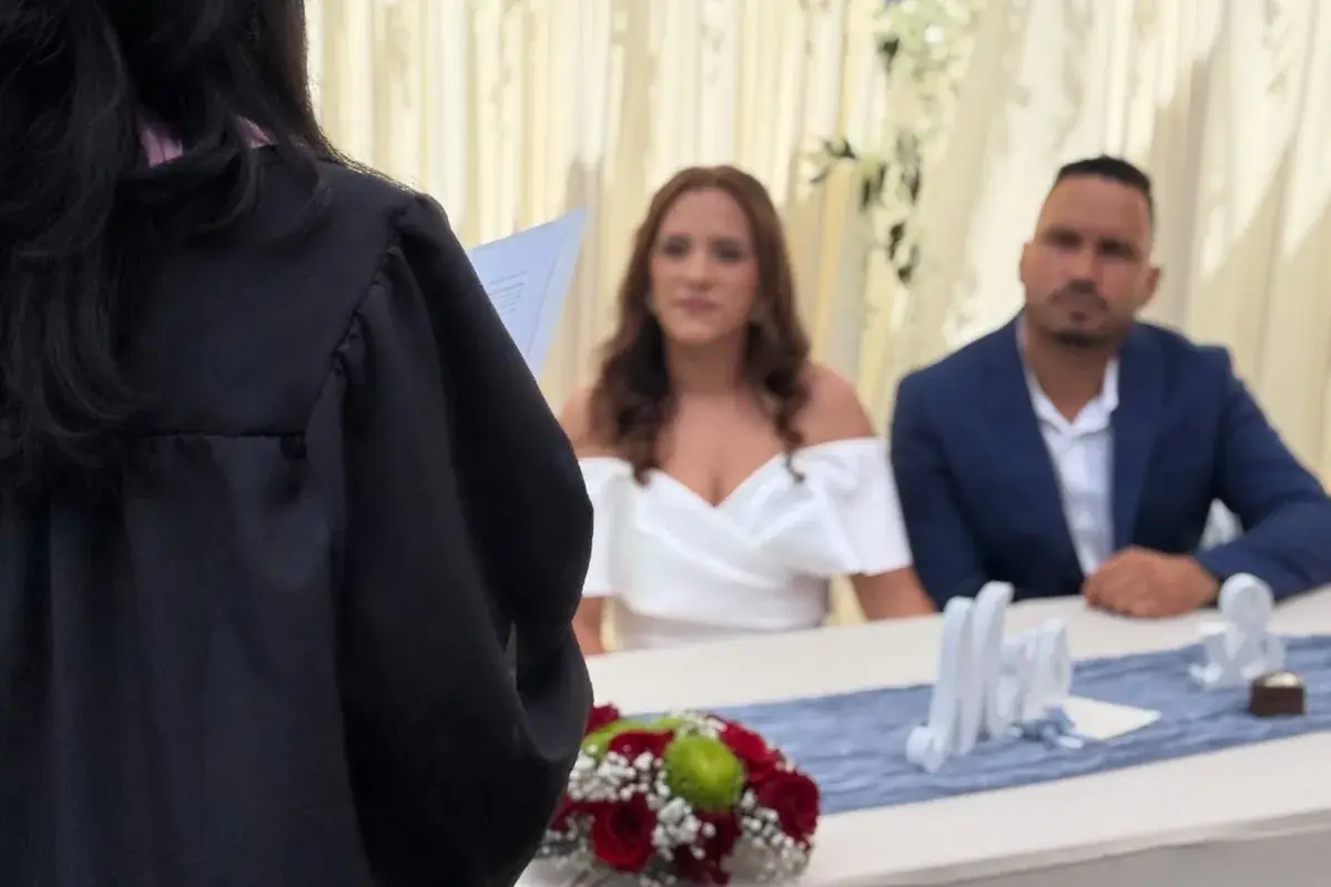 Wedding officiant speaking to a couple